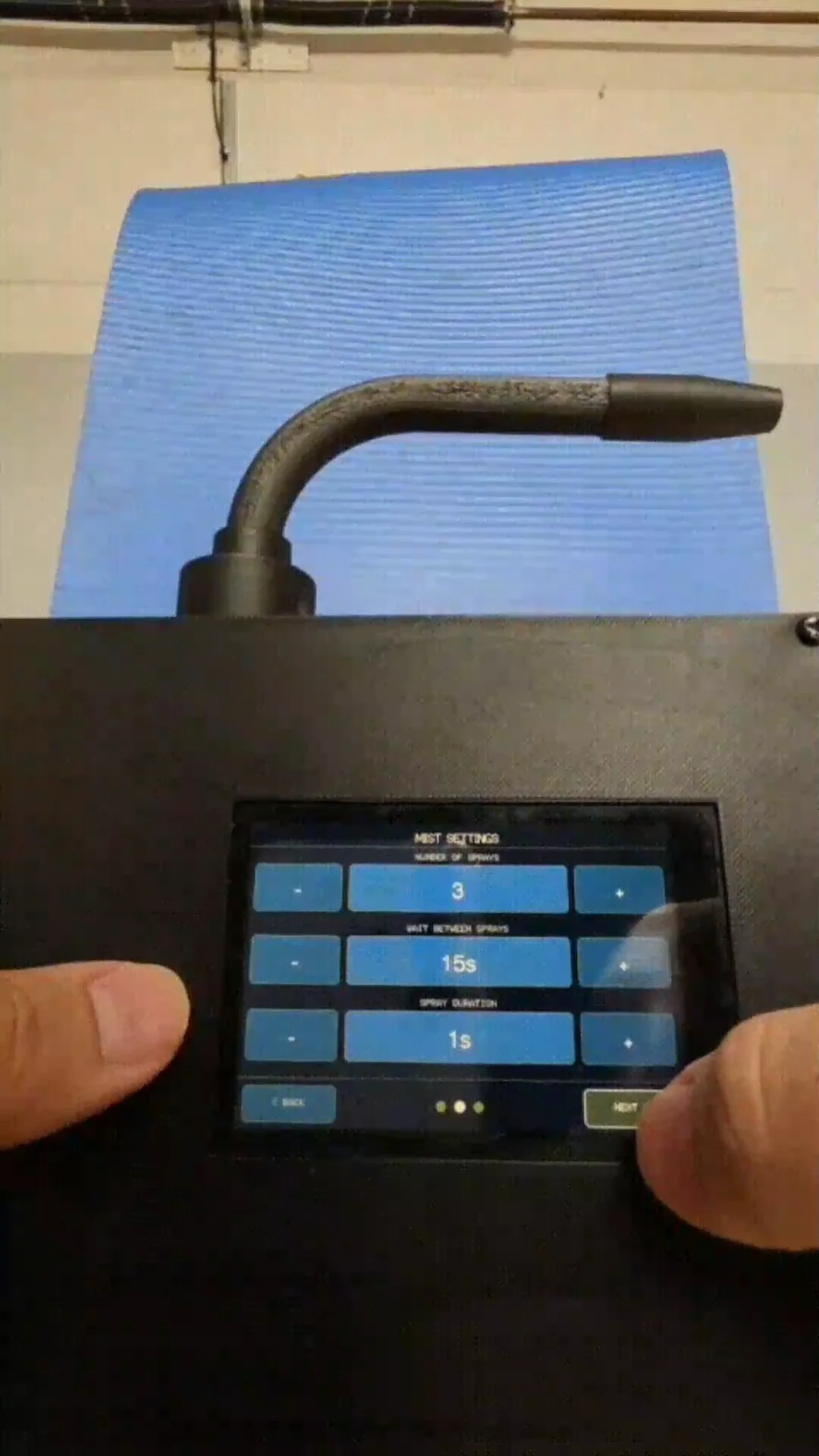 Working prototype: real photo of the touchscreen showing mist settings — number of sprays, wait between sprays, spray duration